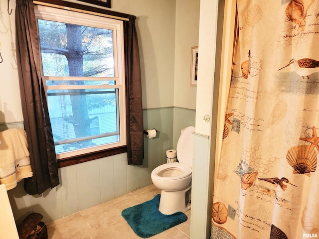 bathroom featuring tile patterned flooring and toilet