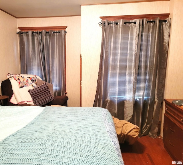 bedroom featuring crown molding and wood-type flooring