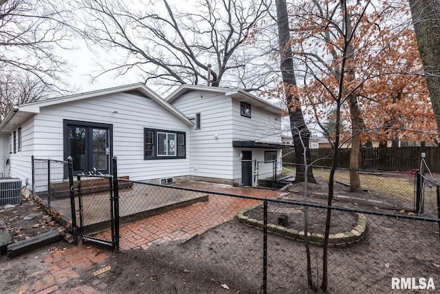 rear view of house featuring central AC