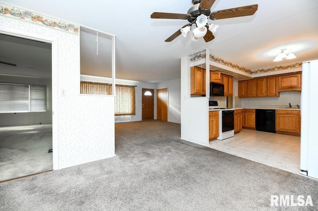 kitchen featuring light carpet, sink, ceiling fan, and black appliances