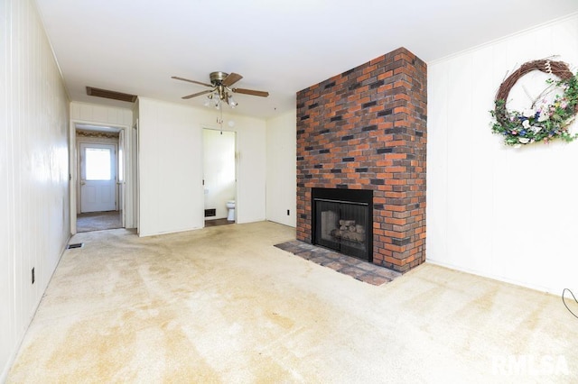 unfurnished living room featuring ceiling fan, light colored carpet, and a fireplace