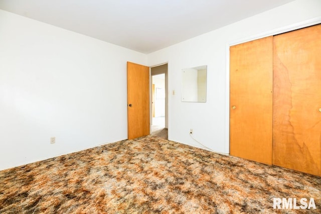 unfurnished bedroom with carpet floors and a closet