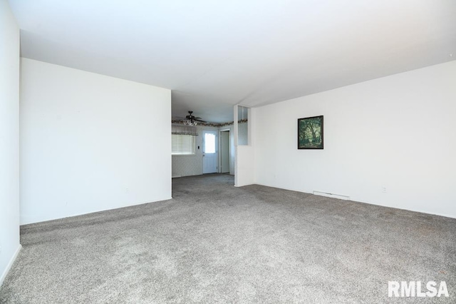 unfurnished living room featuring carpet floors and ceiling fan