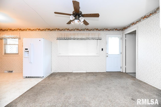 interior space with ceiling fan