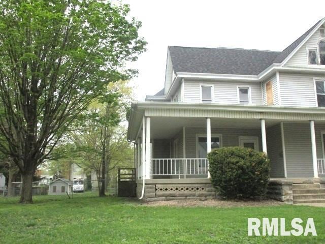 534 S Main St, Canton, IL 61520 - view of side of home with a porch and a yard