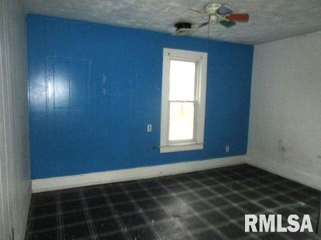 unfurnished room with ceiling fan