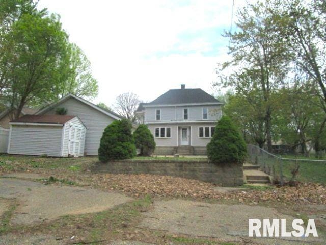 534 S Main St, Canton, IL 61520 - rear view of house with a chimney