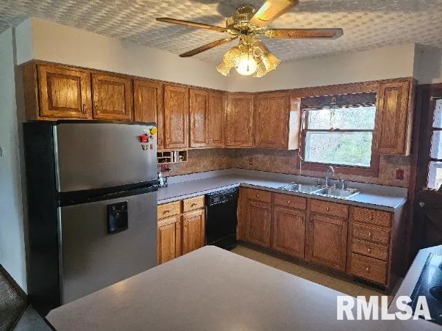 kitchen with stainless steel refrigerator, ceiling fan, dishwasher, and sink