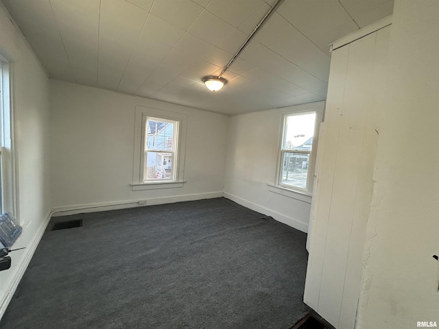 carpeted empty room with plenty of natural light