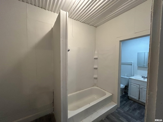 full bathroom with hardwood / wood-style floors, vanity, toilet, and shower / tub combination