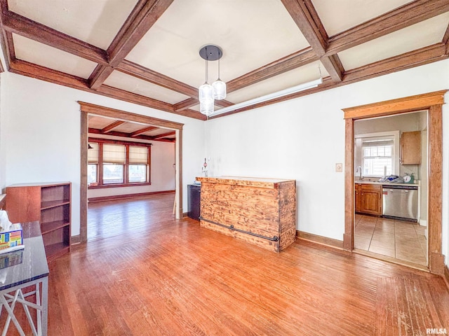 interior space featuring beam ceiling, light hardwood / wood-style flooring, and coffered ceiling