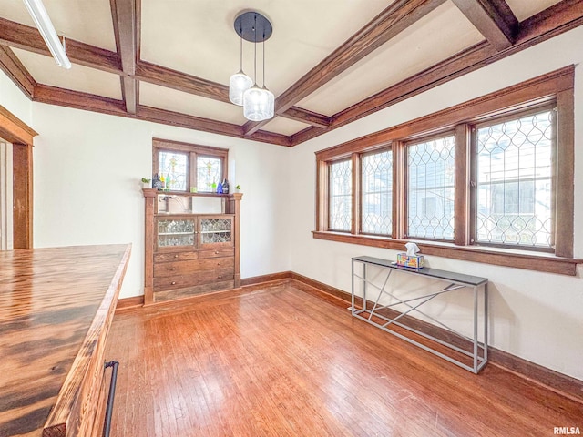 unfurnished dining area with beamed ceiling, hardwood / wood-style flooring, and coffered ceiling