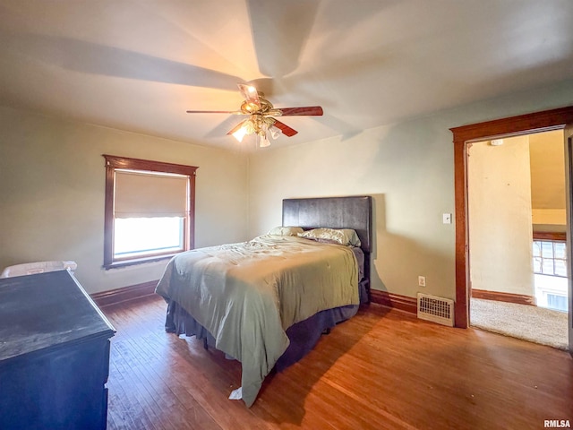 bedroom with ceiling fan and dark hardwood / wood-style floors