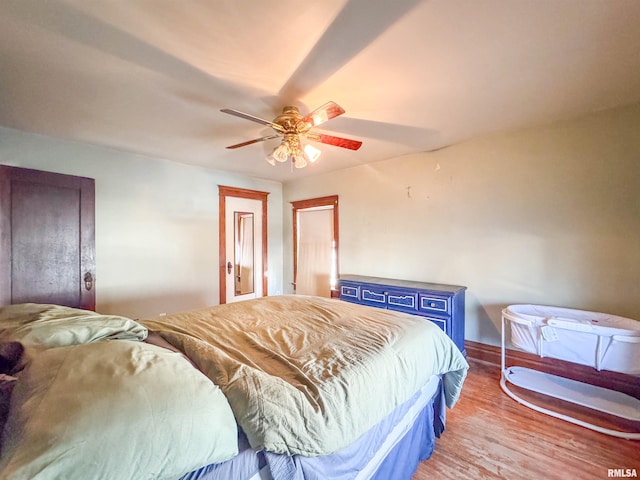 bedroom with ceiling fan and wood-type flooring