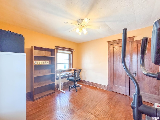 office area featuring hardwood / wood-style flooring, ceiling fan, and a textured ceiling