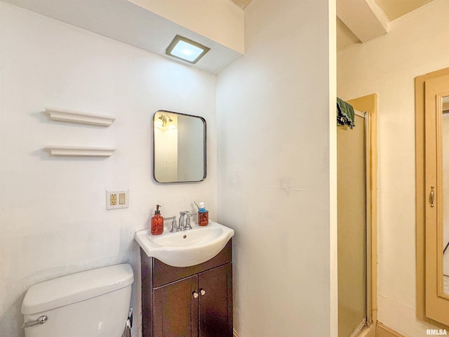 bathroom featuring vanity, toilet, and an enclosed shower