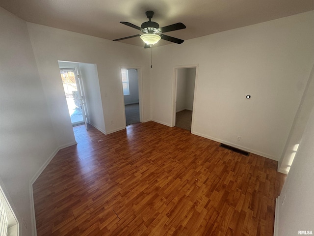 spare room featuring dark hardwood / wood-style floors and ceiling fan