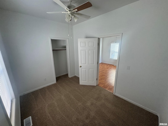 unfurnished bedroom with ceiling fan and carpet