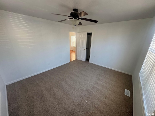 carpeted empty room with ceiling fan