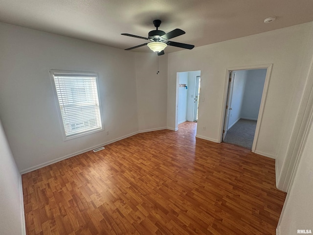 spare room with ceiling fan and wood-type flooring