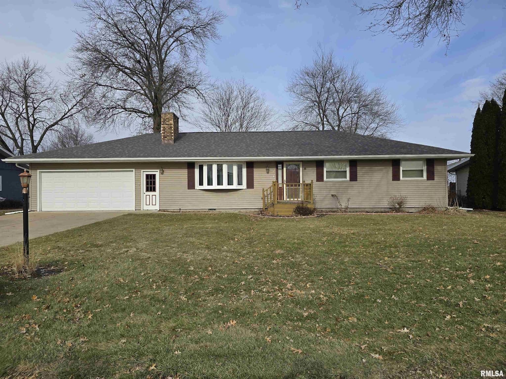 ranch-style house featuring a garage and a front yard