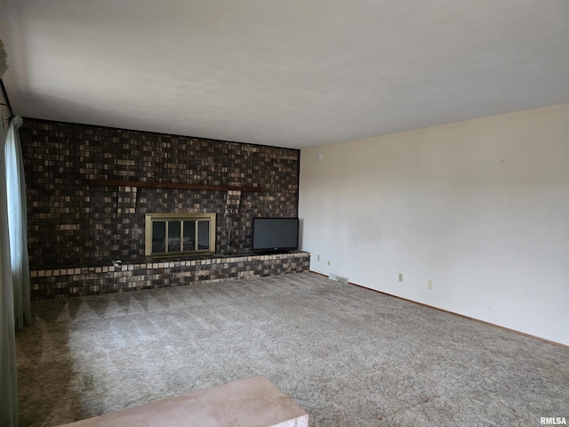 unfurnished living room featuring carpet and a brick fireplace