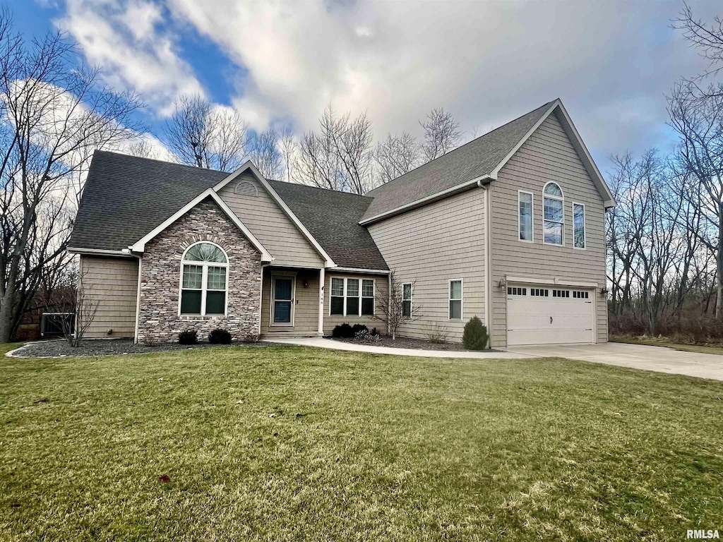 view of front of property featuring a garage and a front lawn