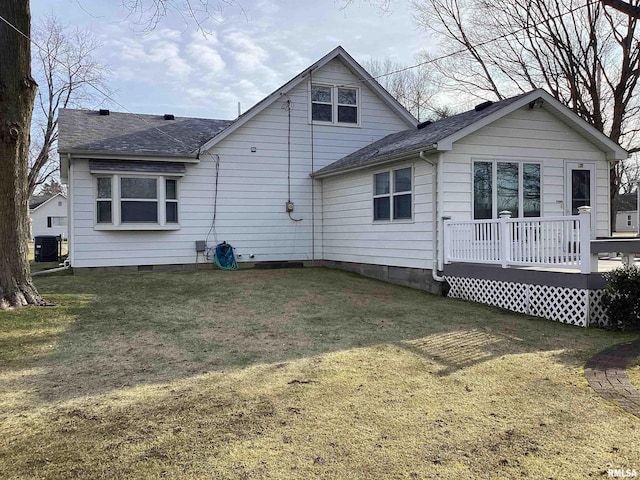 rear view of house with a lawn, central air condition unit, and a wooden deck