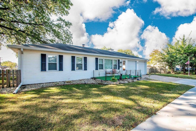 ranch-style home featuring a garage and a front lawn