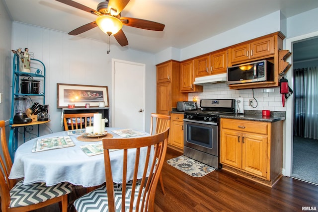 kitchen featuring ceiling fan, dark hardwood / wood-style flooring, backsplash, and appliances with stainless steel finishes