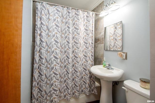 bathroom with a shower with shower curtain and toilet