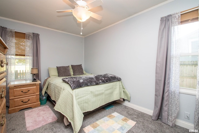 bedroom with dark colored carpet, ceiling fan, and crown molding