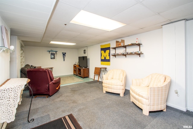 living room with carpet and a drop ceiling