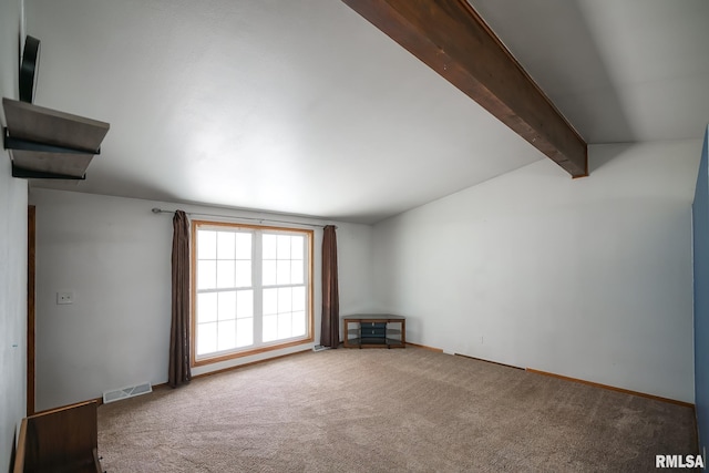 unfurnished living room with carpet flooring and lofted ceiling with beams