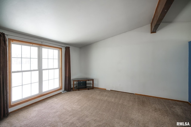 unfurnished living room featuring vaulted ceiling with beams and carpet floors