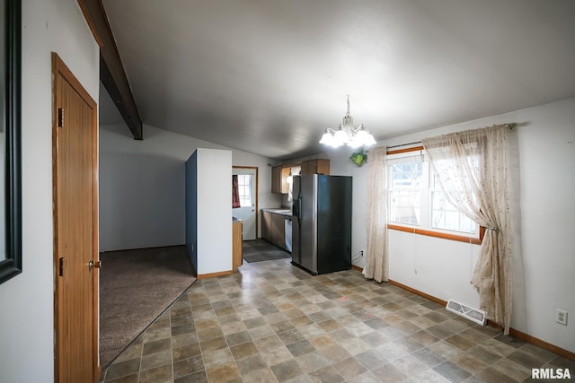 kitchen featuring vaulted ceiling with beams, stainless steel fridge, and a chandelier