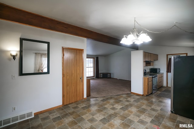 kitchen featuring appliances with stainless steel finishes, vaulted ceiling, and a notable chandelier