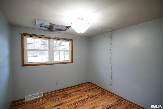 unfurnished room featuring hardwood / wood-style floors