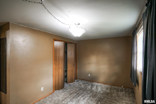 unfurnished bedroom with carpet flooring and a closet