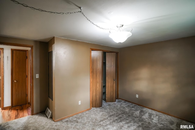 unfurnished bedroom featuring carpet and a closet