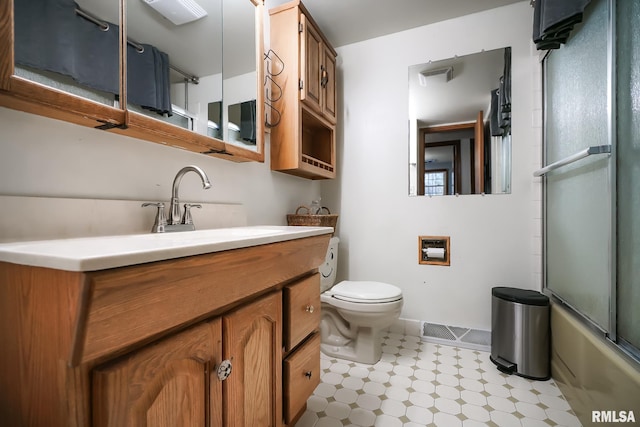 full bathroom with vanity, toilet, and shower / bath combination with glass door