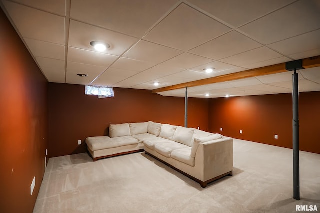 unfurnished living room with a drop ceiling and carpet floors