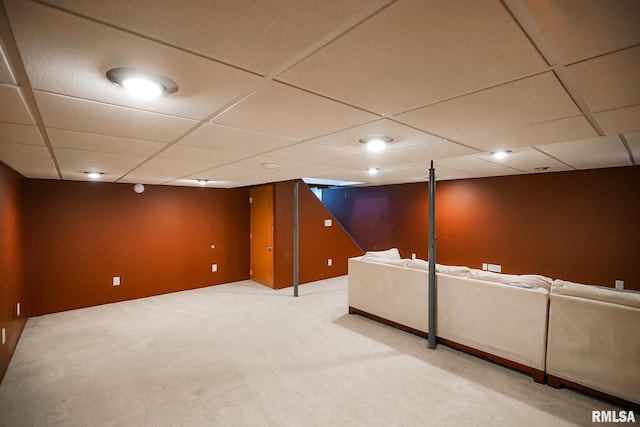 basement with a drop ceiling and carpet