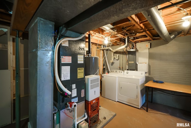 basement with electric panel and washer and clothes dryer