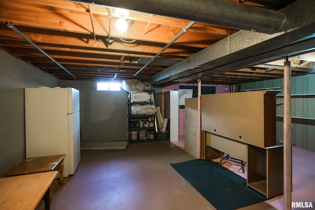 basement featuring white fridge