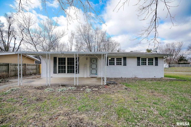 ranch-style home with a front yard and a patio