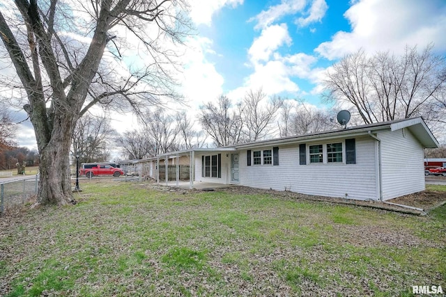 rear view of house featuring a yard