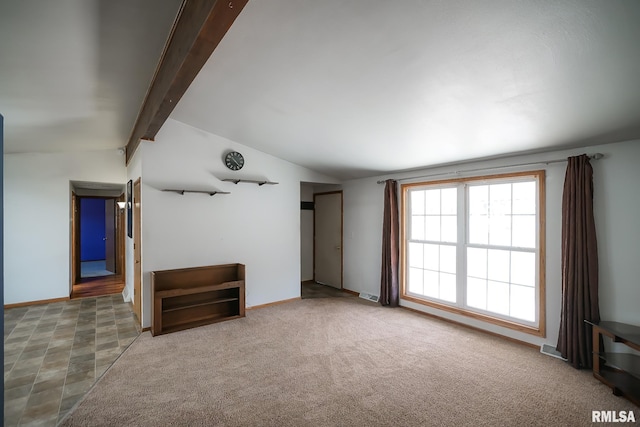 unfurnished living room with vaulted ceiling with beams and carpet floors