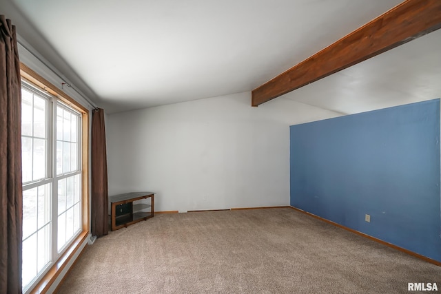 unfurnished living room featuring vaulted ceiling with beams and carpet floors