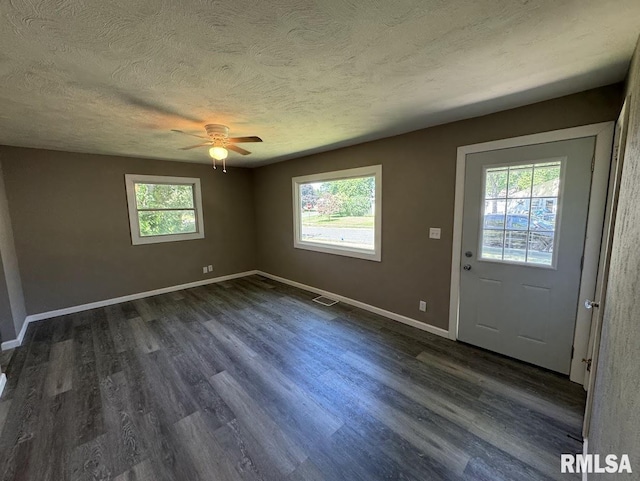 entryway with dark hardwood / wood-style floors, ceiling fan, and a textured ceiling